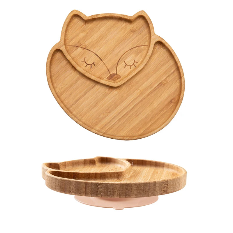 Bamboo baby plate designed in the shape of a sleeping fox face, featuring divided sections and a suction base for stability, ideal for toddler meals and baby-led weaning.