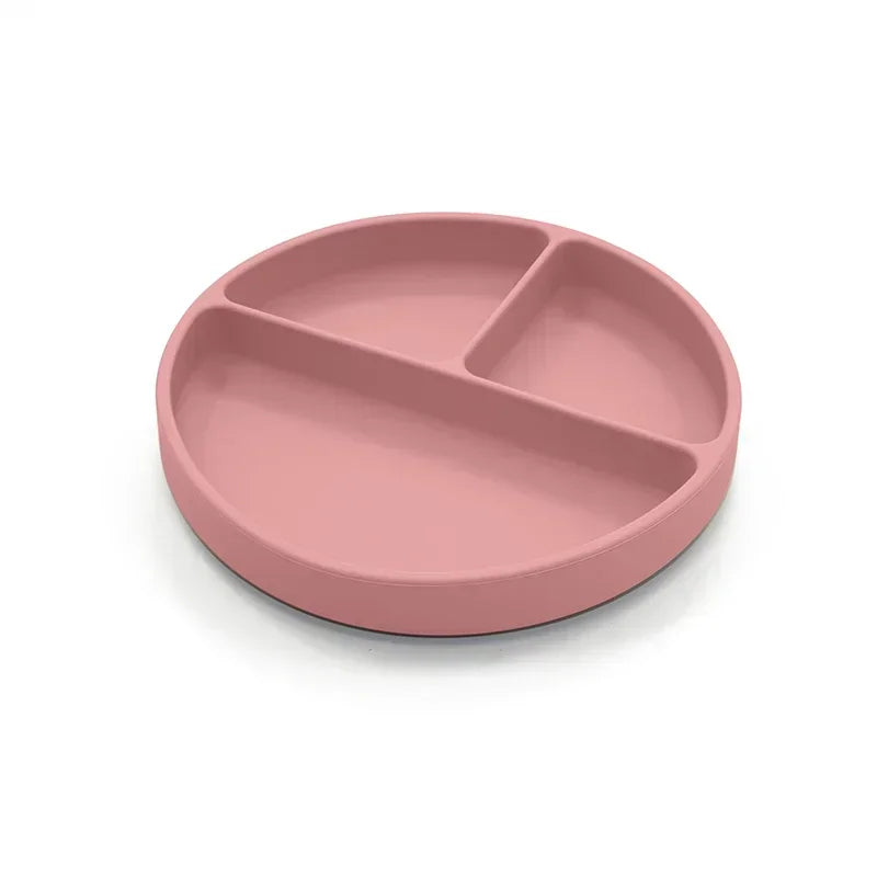 Rose-colored silicone divided plate with three compartments, designed for toddler meals, portion control, and easy cleaning, ideal for baby-led weaning and independent eating.