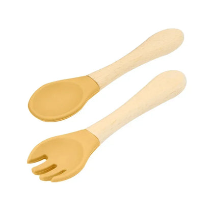 Set of natural wooden baby utensils featuring a spoon and fork with honey yellow silicone tips, combining eco-friendly wooden handles with soft-touch feeding ends for safe and comfortable baby mealtimes