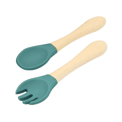 Set of natural wooden baby utensils featuring a spoon and fork with mint green silicone tips, combining sustainable wooden handles with soft silicone ends for comfortable and safe infant feeding