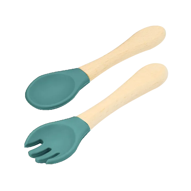 Set of natural wooden baby utensils featuring a spoon and fork with mint green silicone tips, combining sustainable wooden handles with soft silicone ends for comfortable and safe infant feeding