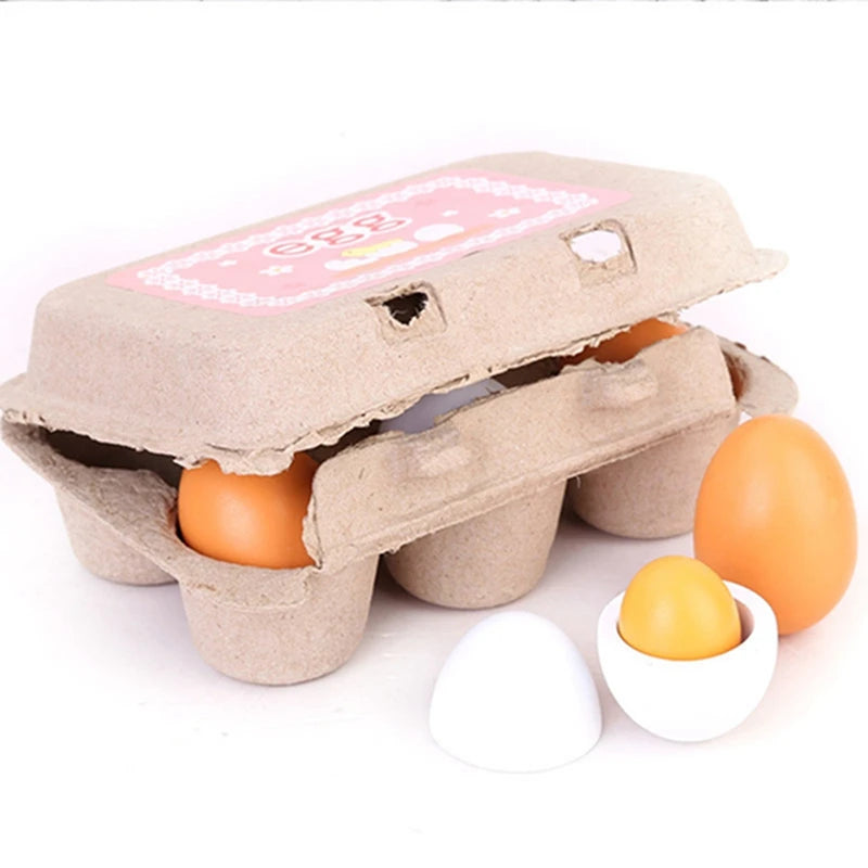 A pretend playset of six wooden eggs in a realistic cardboard carton, featuring two colors (brown and white), with one egg cracked open revealing a yellow yolk.